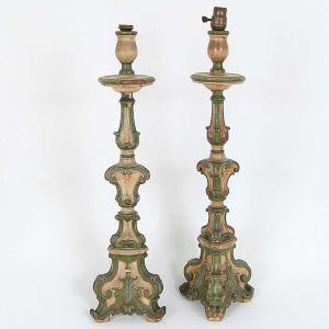 Antigo <b>par de tocheiros</b> adaptados para luz elétrica em madeira patinada em bege e verde com entalhes ao gosto barroco. Alguns descascados. Alt. 74 cm