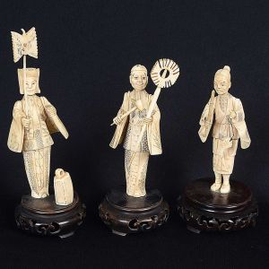 Conjunto de <b>3 antigas estatuetas</b> chinesas em marfim representando personagens masculinos com seus objetos de ofício. Bases em madeira. Alt. da maior 20 cm