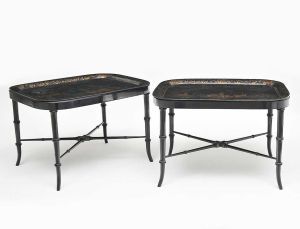 <b>Par de mesas</b> bandejas em madeira laqueada de negro e decoradas com motivos "chinoiserie" em dourado. Apresenta base posterior ebanizada. Med. 53 x 78 x 62 cm
